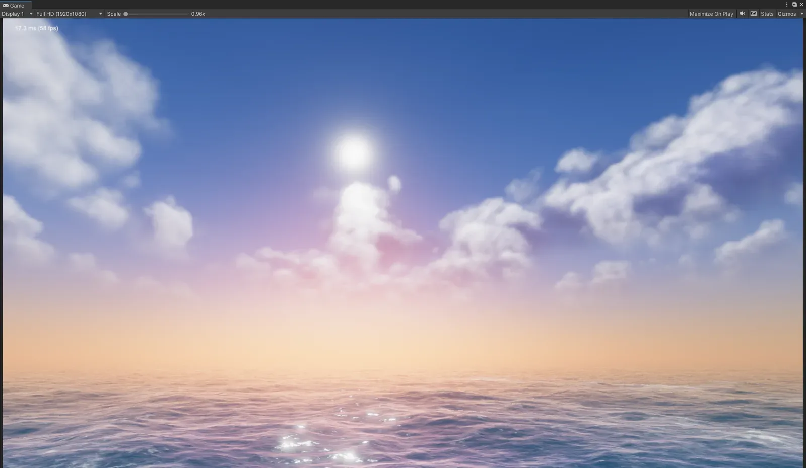 A sunset sky with clouds above a rippled sea, with haze fading toward the horizon.